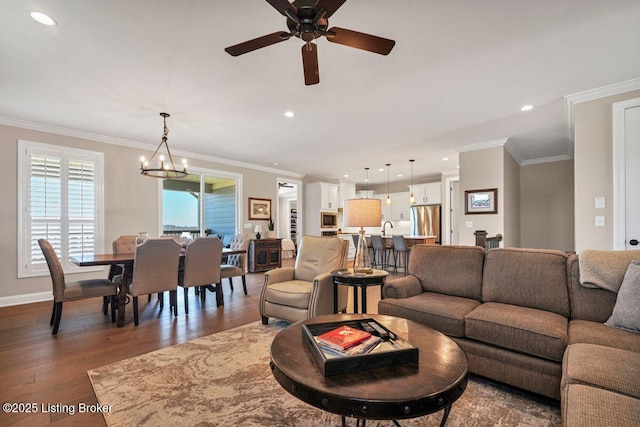 living area featuring recessed lighting, wood finished floors, baseboards, and ornamental molding