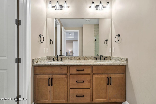 bathroom featuring double vanity, visible vents, a stall shower, and a sink