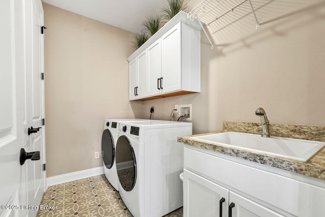 washroom featuring baseboards, light tile patterned floors, cabinet space, independent washer and dryer, and a sink