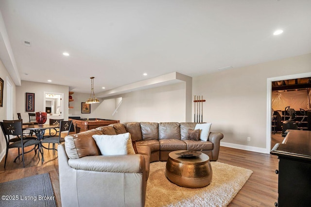 living area with recessed lighting, wood finished floors, and baseboards