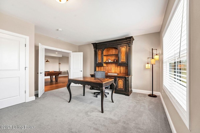 home office featuring light colored carpet, billiards, and baseboards