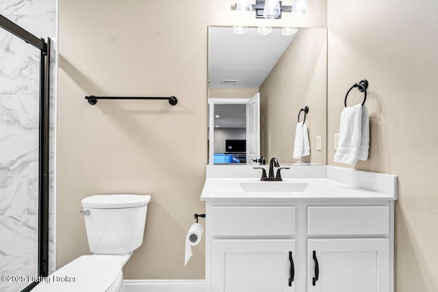 bathroom with a marble finish shower, toilet, visible vents, and vanity