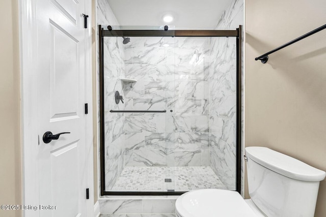 bathroom with a marble finish shower, toilet, and marble finish floor