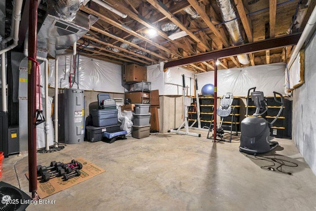 unfinished basement featuring electric water heater