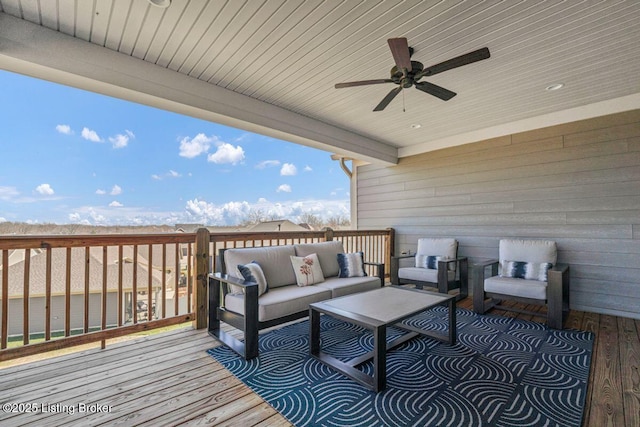 wooden deck with an outdoor hangout area and ceiling fan