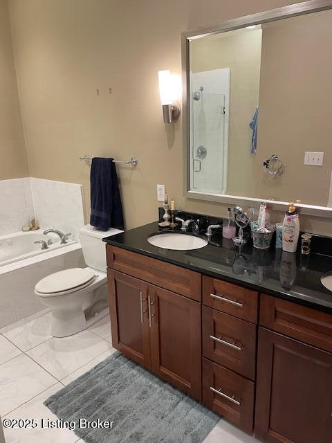 324 E Main St Unit 405, Louisville, KY 40202 - full bathroom featuring tile patterned floors, toilet, vanity, and shower with separate bathtub