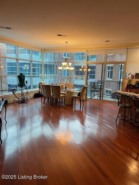 dining room featuring hardwood / wood-style floors and a chandelier