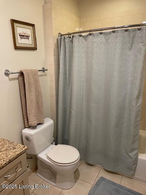 324 E Main St Unit 405, Louisville, KY 40202 - full bathroom with shower / bath combo with shower curtain, vanity, tile patterned flooring, and toilet
