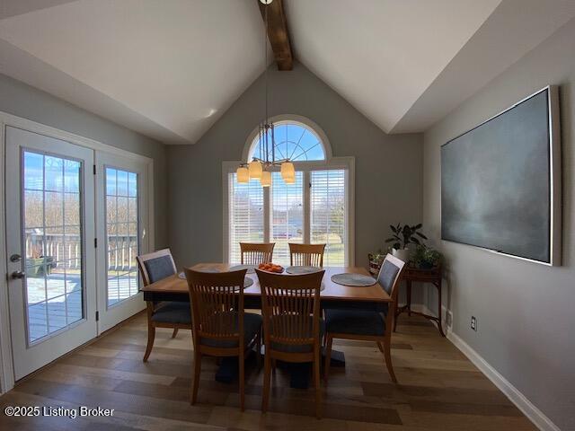 dining area featuring lofted ceiling with beams and hardwood / wood-style floors