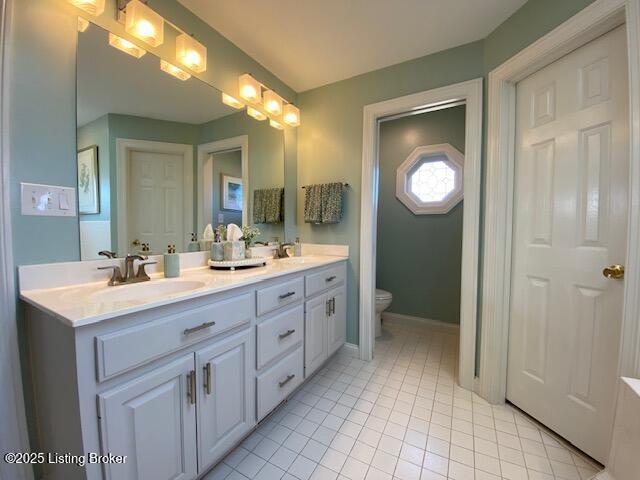 bathroom with vanity, tile patterned floors, and toilet