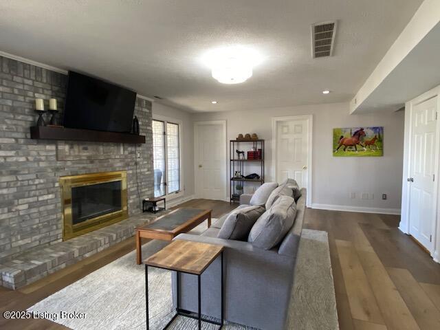 living room with hardwood / wood-style floors and a fireplace