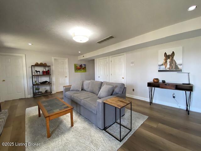 living room with dark hardwood / wood-style flooring