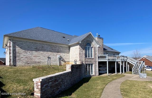 view of home's exterior with a yard and a deck