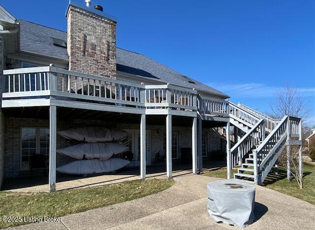 rear view of house featuring a patio and a deck