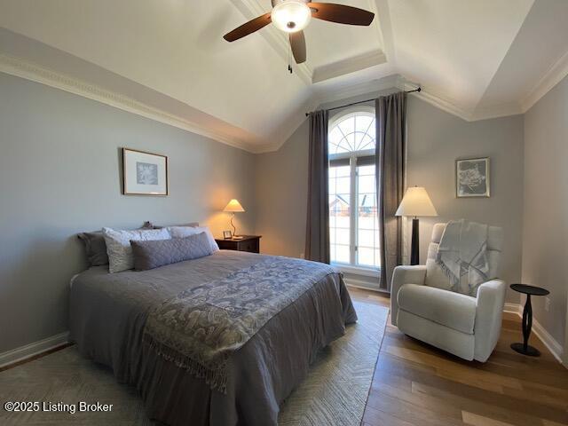 bedroom with hardwood / wood-style flooring, ceiling fan, lofted ceiling, and crown molding