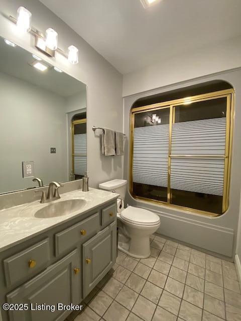 full bathroom with tile patterned flooring, enclosed tub / shower combo, vanity, and toilet