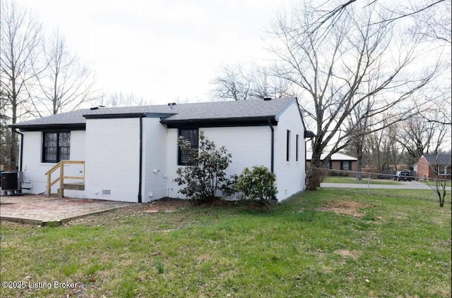 view of home's exterior featuring a lawn, a patio, and central air condition unit