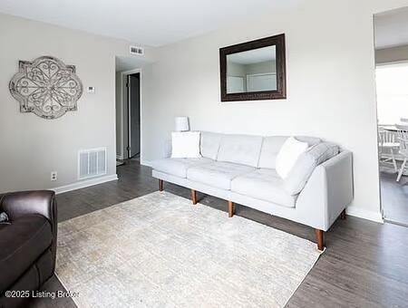 living room with dark wood-type flooring