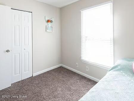 unfurnished bedroom featuring carpet flooring and a closet