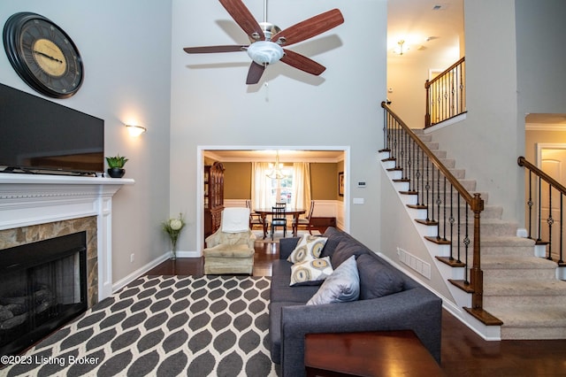 110 E Mandarin Ct, Elizabethtown, KY 42701 - living room featuring a towering ceiling, ceiling fan with notable chandelier, a fireplace, and dark hardwood / wood-style flooring