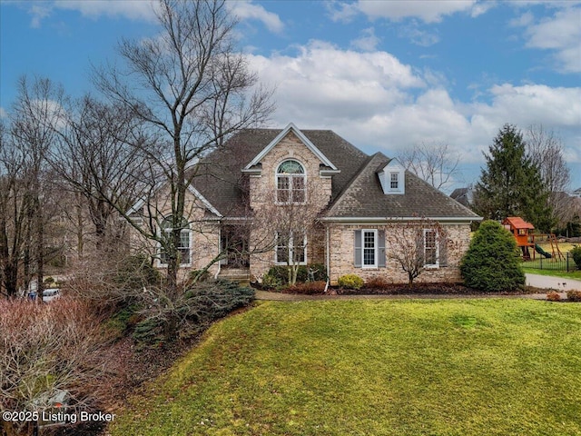 view of front of house with a playground and a front lawn