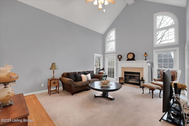 living room with high vaulted ceiling and light wood-type flooring