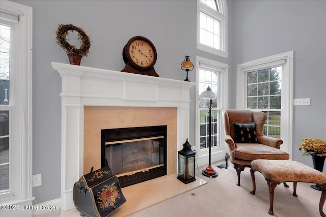 sitting room with carpet flooring and a high end fireplace