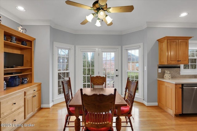 dining room with crown molding, ceiling fan, and light hardwood / wood-style flooring