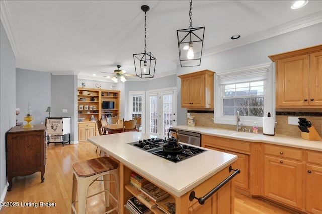 kitchen with sink, dishwasher, hanging light fixtures, black gas cooktop, and a kitchen island