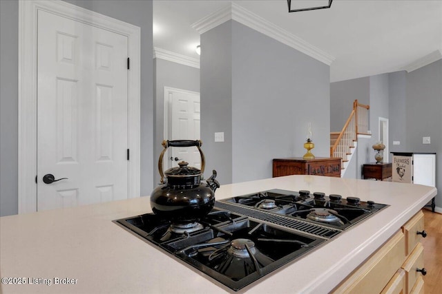 kitchen with hardwood / wood-style floors, ornamental molding, black gas cooktop, and light brown cabinets