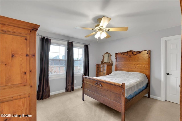 bedroom with ceiling fan and light carpet