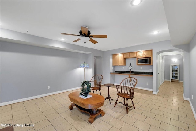 sitting room with ceiling fan and light tile patterned floors