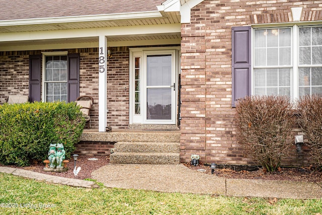 view of exterior entry featuring covered porch