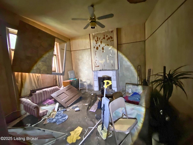 misc room featuring ceiling fan and a fireplace