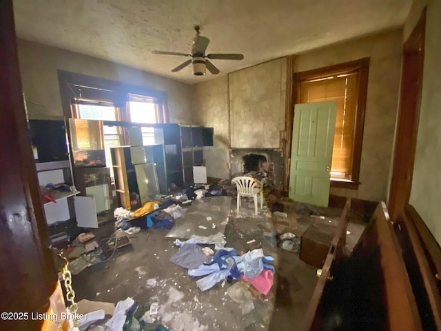 miscellaneous room with ceiling fan and a fireplace