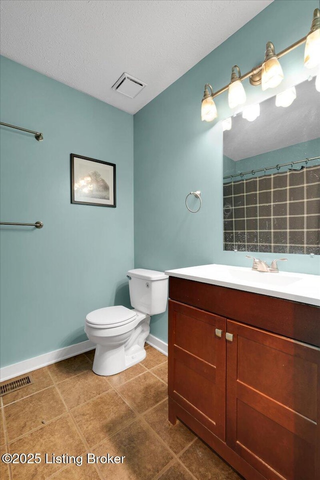 bathroom featuring vanity, toilet, tile patterned floors, a textured ceiling, and a shower with curtain