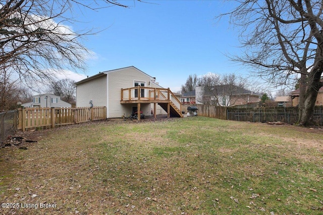 rear view of house featuring a yard and a deck