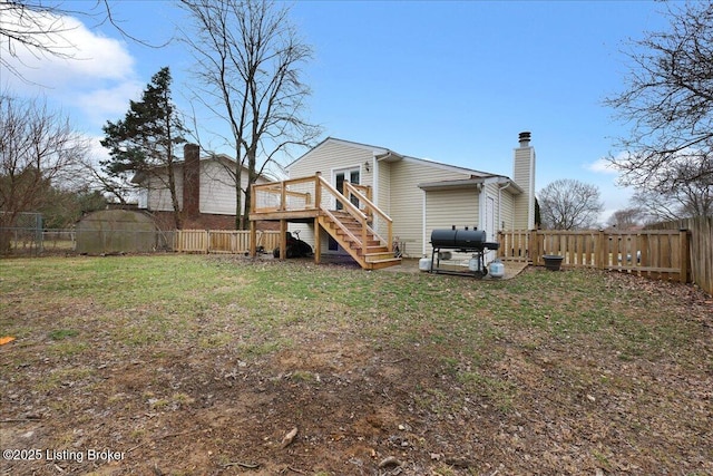 back of house with a lawn and a deck