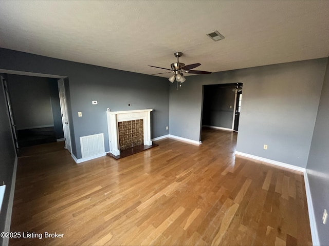 223 Lea Ct, Rineyville, KY 40162 - unfurnished living room with visible vents, baseboards, ceiling fan, and wood finished floors