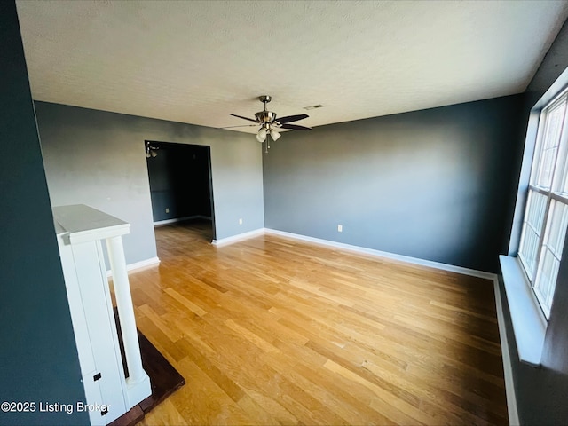 223 Lea Ct, Rineyville, KY 40162 - spare room featuring visible vents, light wood-style flooring, a textured ceiling, baseboards, and ceiling fan