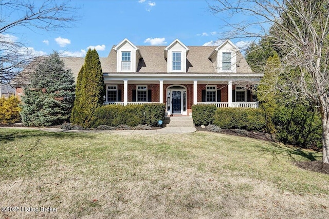 cape cod house with a porch and a front lawn