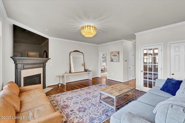 living room featuring dark hardwood / wood-style flooring, crown molding, and a fireplace