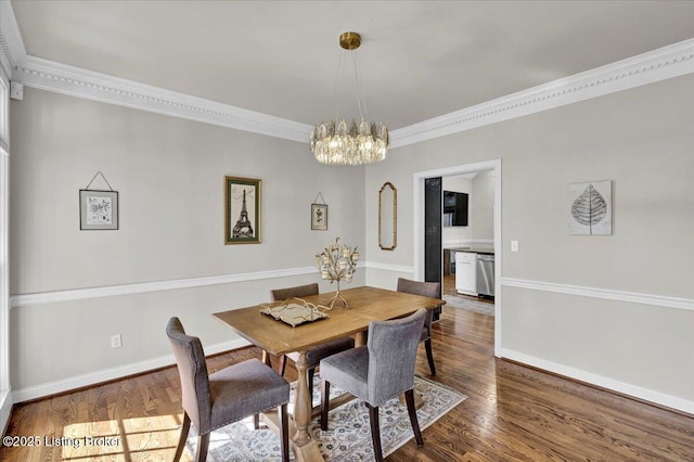 dining room with dark hardwood / wood-style flooring, a notable chandelier, and crown molding