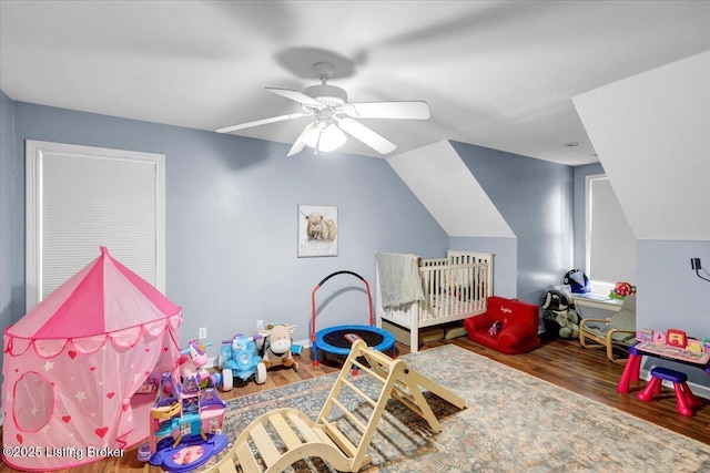 game room with hardwood / wood-style flooring, ceiling fan, and vaulted ceiling