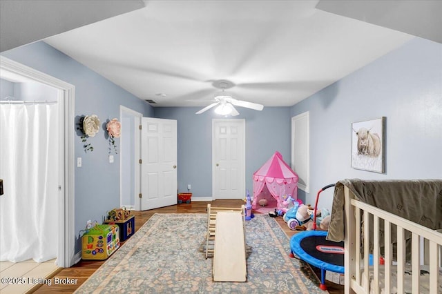 bedroom with wood-type flooring and ceiling fan