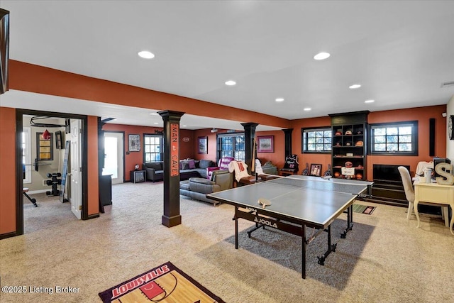 playroom featuring light colored carpet, plenty of natural light, and decorative columns