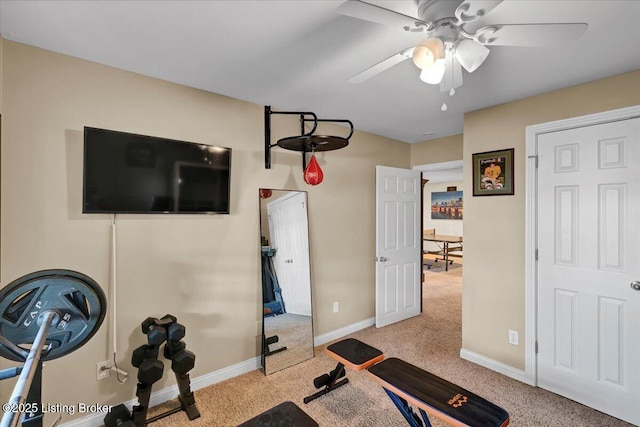 workout room featuring light carpet and ceiling fan