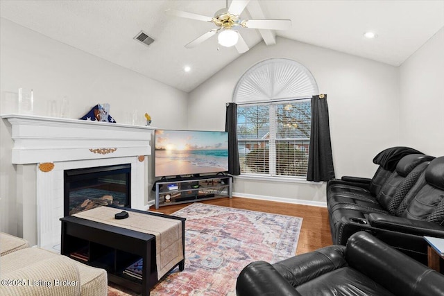 living room with vaulted ceiling with beams, wood-type flooring, and ceiling fan