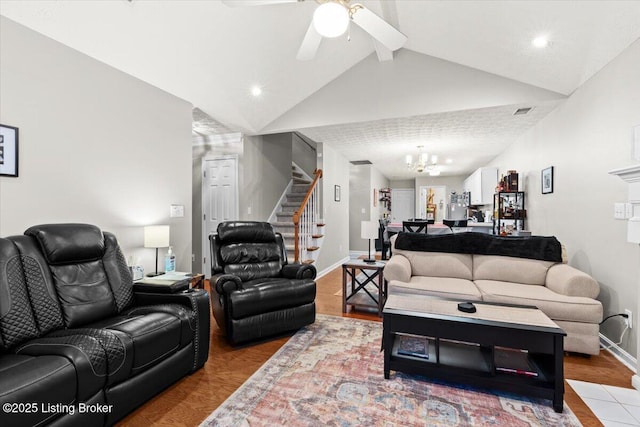 living room with vaulted ceiling with beams, ceiling fan with notable chandelier, and light hardwood / wood-style floors