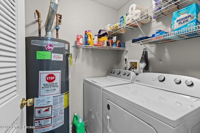 clothes washing area with water heater and washer and clothes dryer